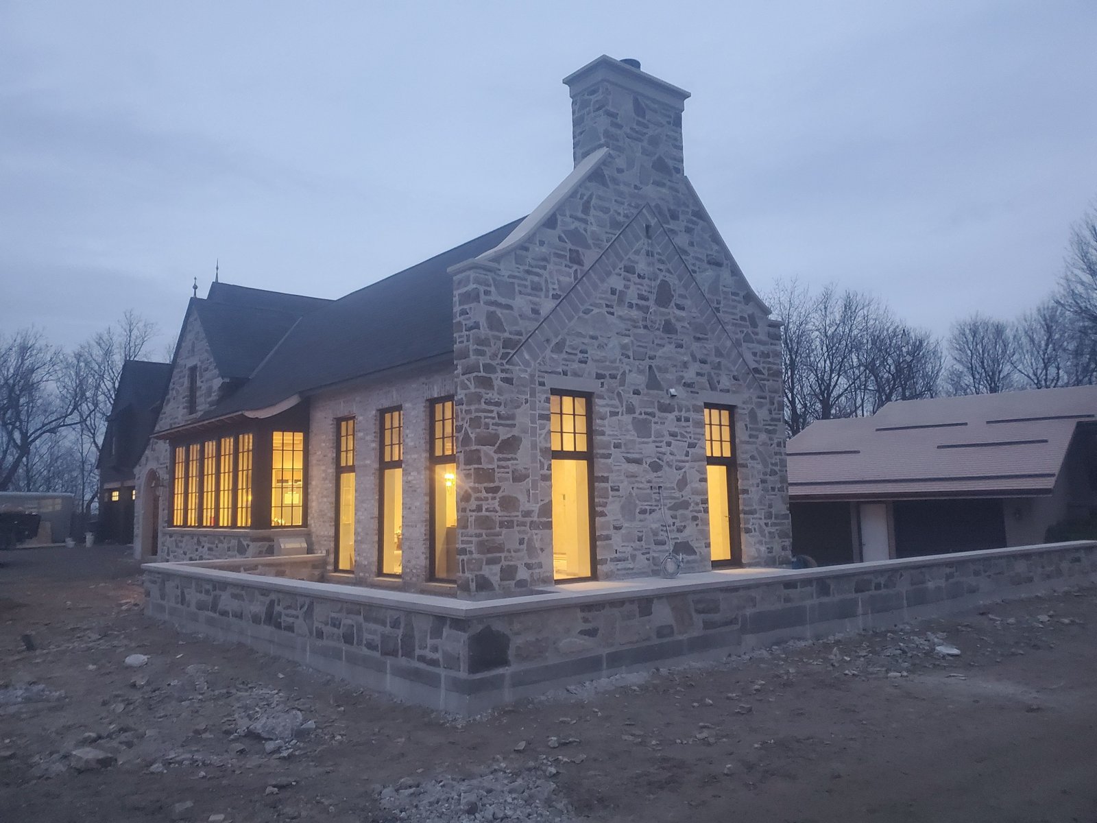A restored heritage stone home glowing at dusk